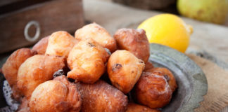 Bowl of Deep fried fritters donuts in rustic country setting