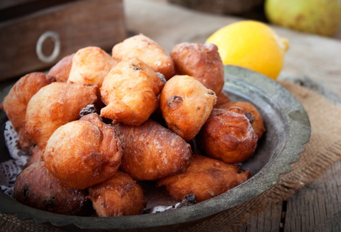 Bowl of Deep fried fritters donuts in rustic country setting