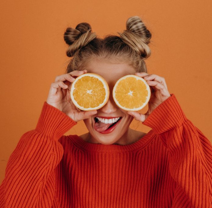 Girl smiling with citrus