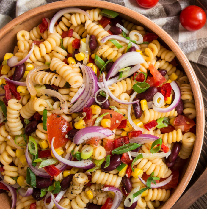 Vegetarian Mexican macaroni pasta salad with red bean, corn, tomato, onion and pepper