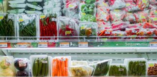 Packaged vegetables on refrigerator shelves at grocery stores