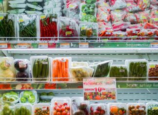 Packaged vegetables on refrigerator shelves at grocery stores