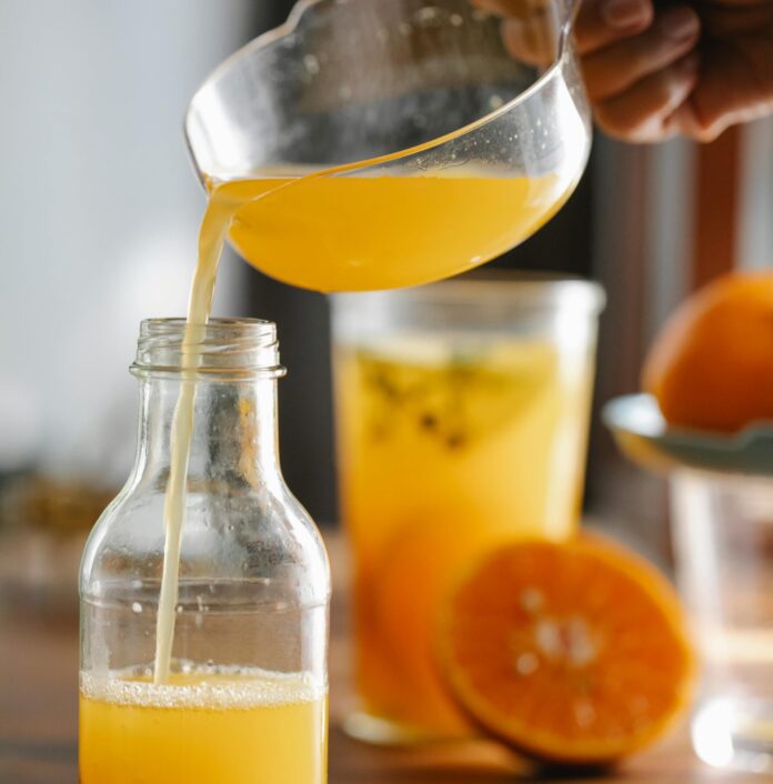 Orange juice poured into a bottle