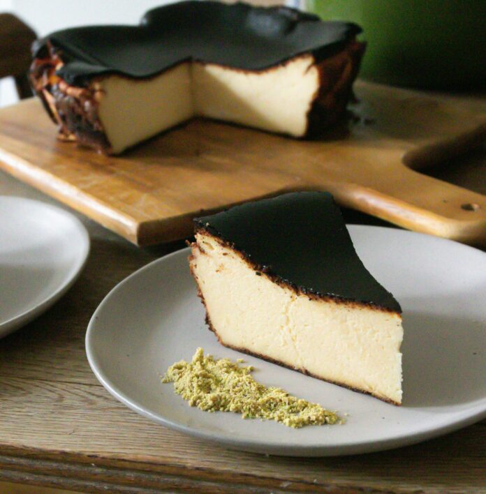 Slice of Basque cheesecake with pistachios