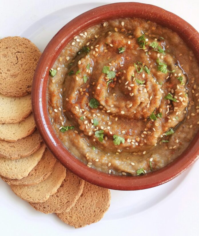 Bowl of baba ghanoush with crackers