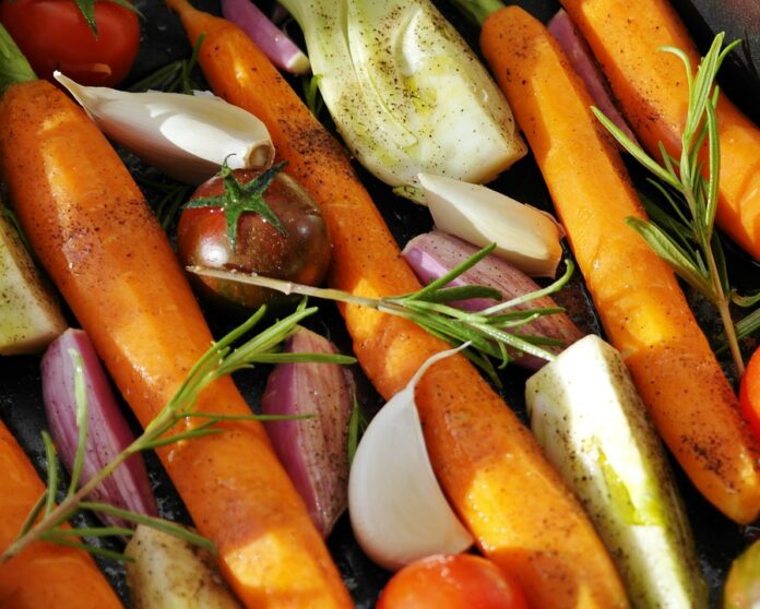 Carrots and vegetables on a baking pan