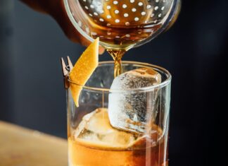 Paper plane cocktail in a rocks glass