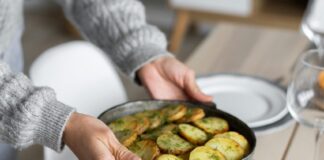 Crop woman serving table for dinner
